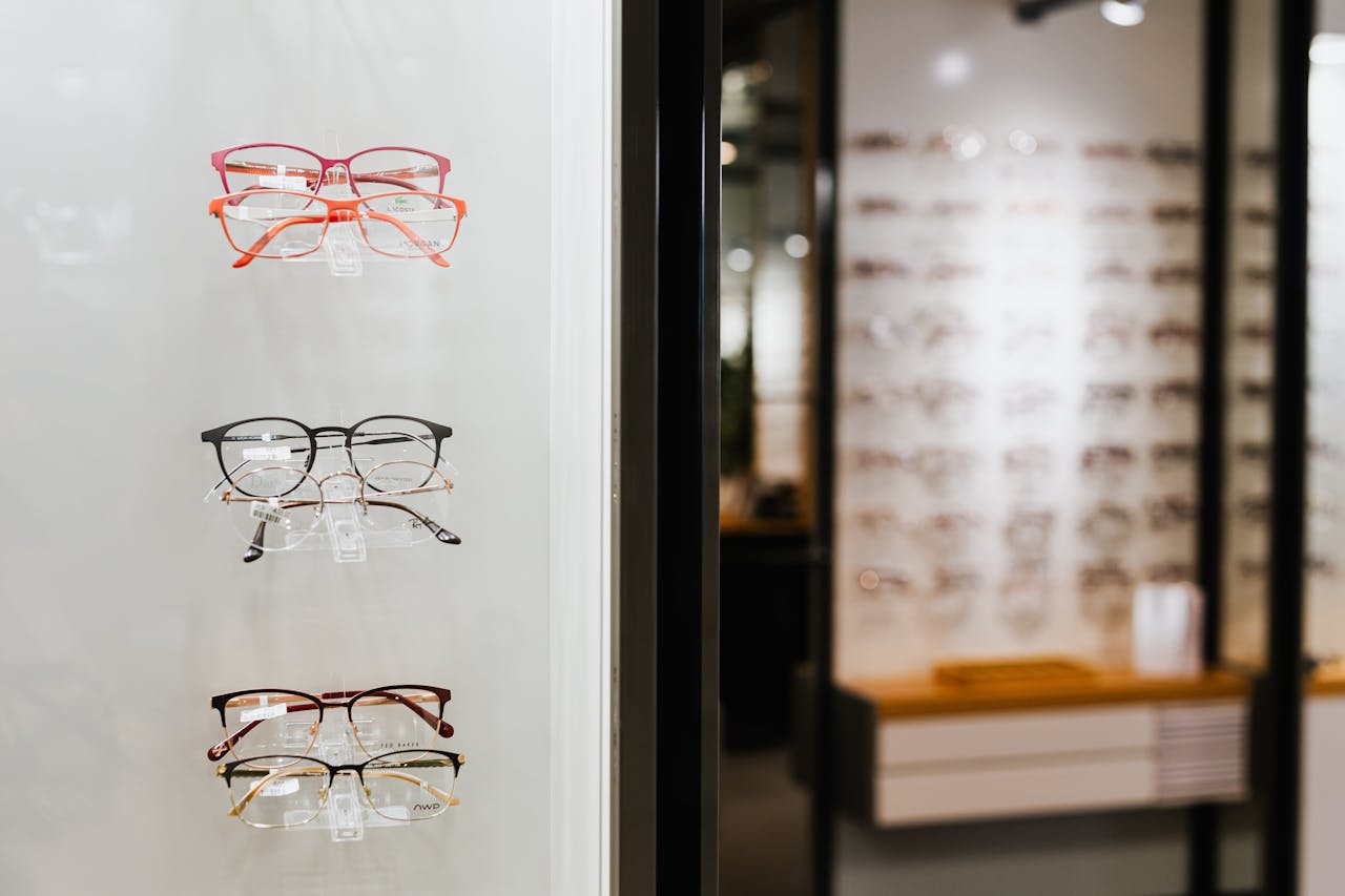 Variety of eyeglasses showcased on wall display in an optical store.